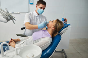 Examination of female teeth by a dentist